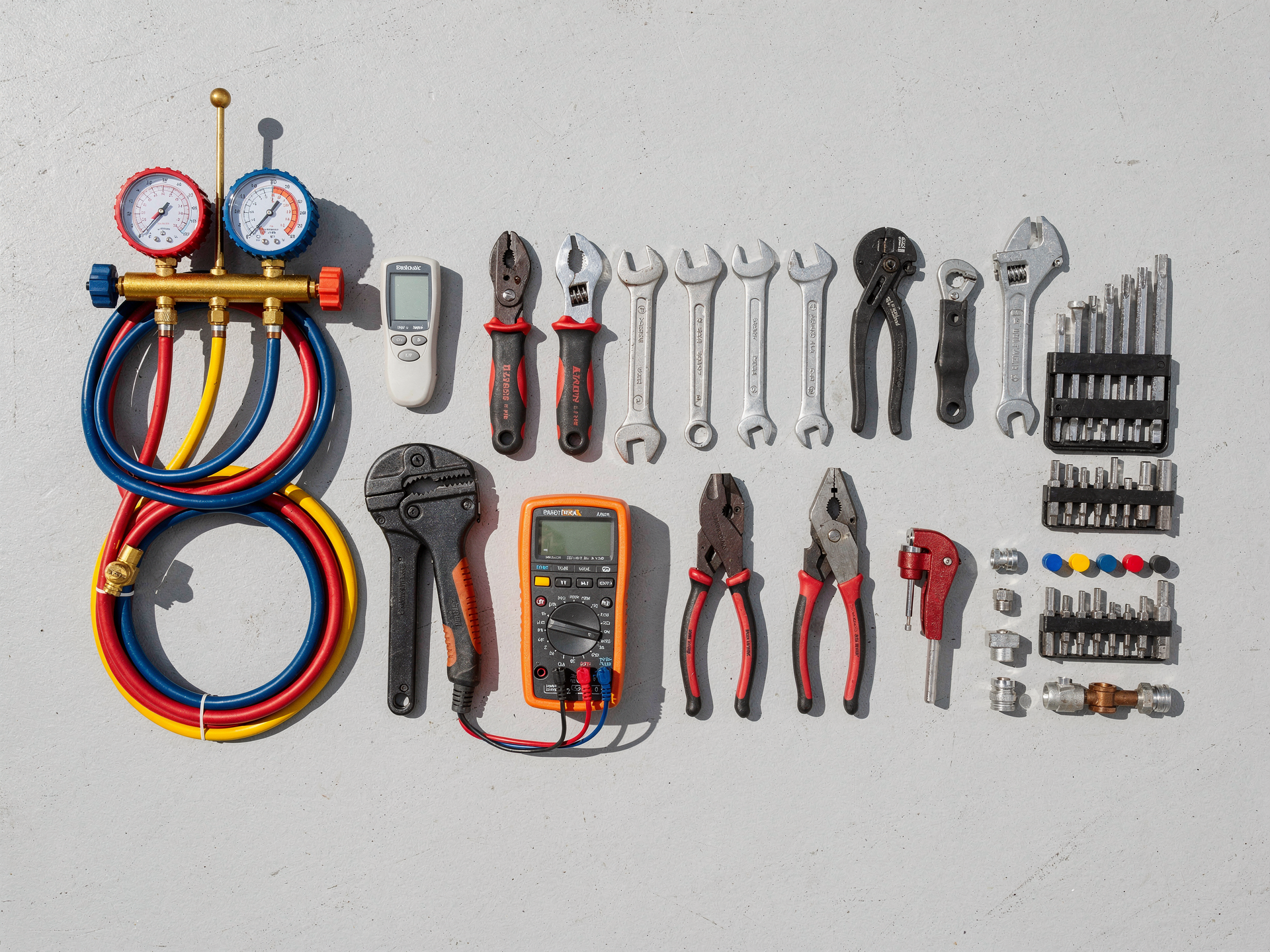 Neatly organized HVAC technician tools and refrigerant gauges in bright daylight